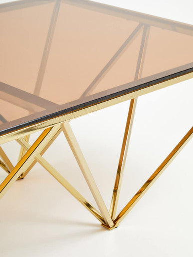 Red-Tinted Tempered Glass Top Coffee Table with Geometric Prismatic Champagne Metal Legs | Allure