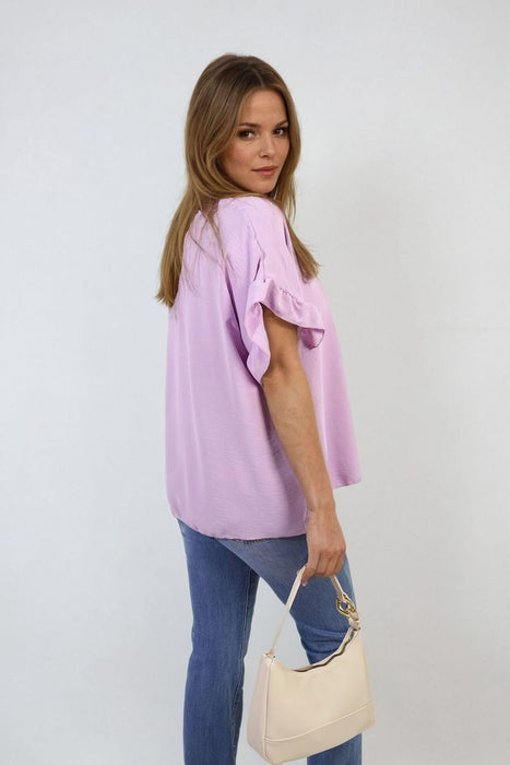 Playful Elegance: Alexandra Frill Sleeve Top - High-quality, versatile and stylish. Elevate your outfit today!